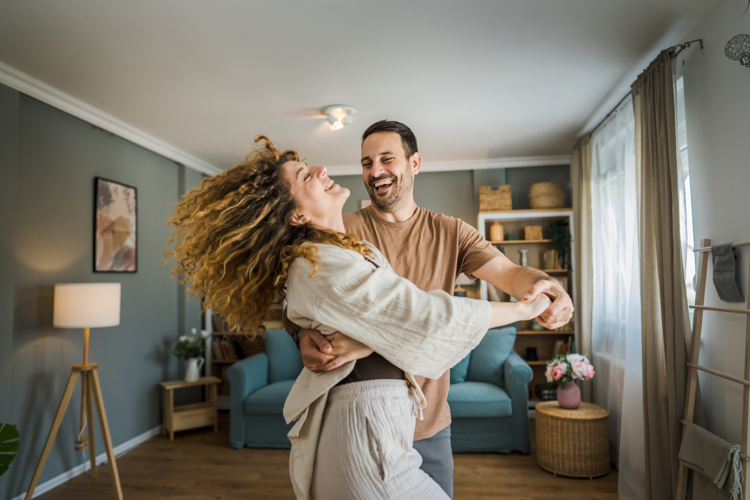 Happy couple adult caucasian man woman husband and wife dance at home
